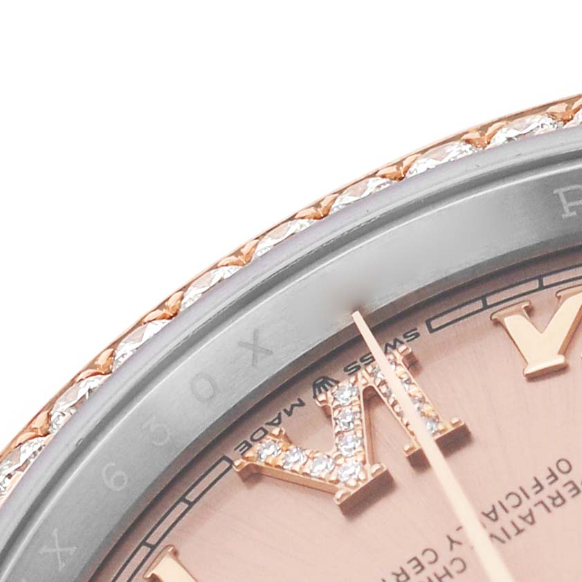 The image shows a close-up of a Rolex Datejust 126281 Men's Steel and Gold (two tone) Pink Dial watch bezel, dial, and hands, featuring Roman numerals and diamond details.