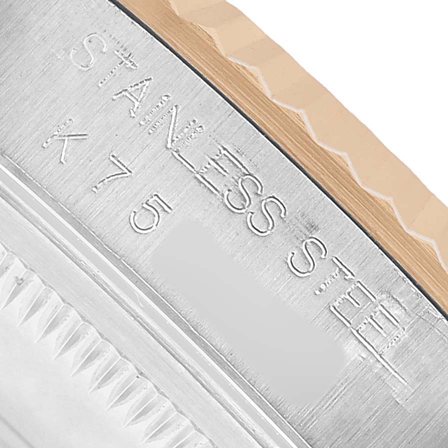 The image shows a close-up of the stainless steel and fluted bezel of a Rolex Datejust 16233 Men's Stainless Steel White Dial watch.