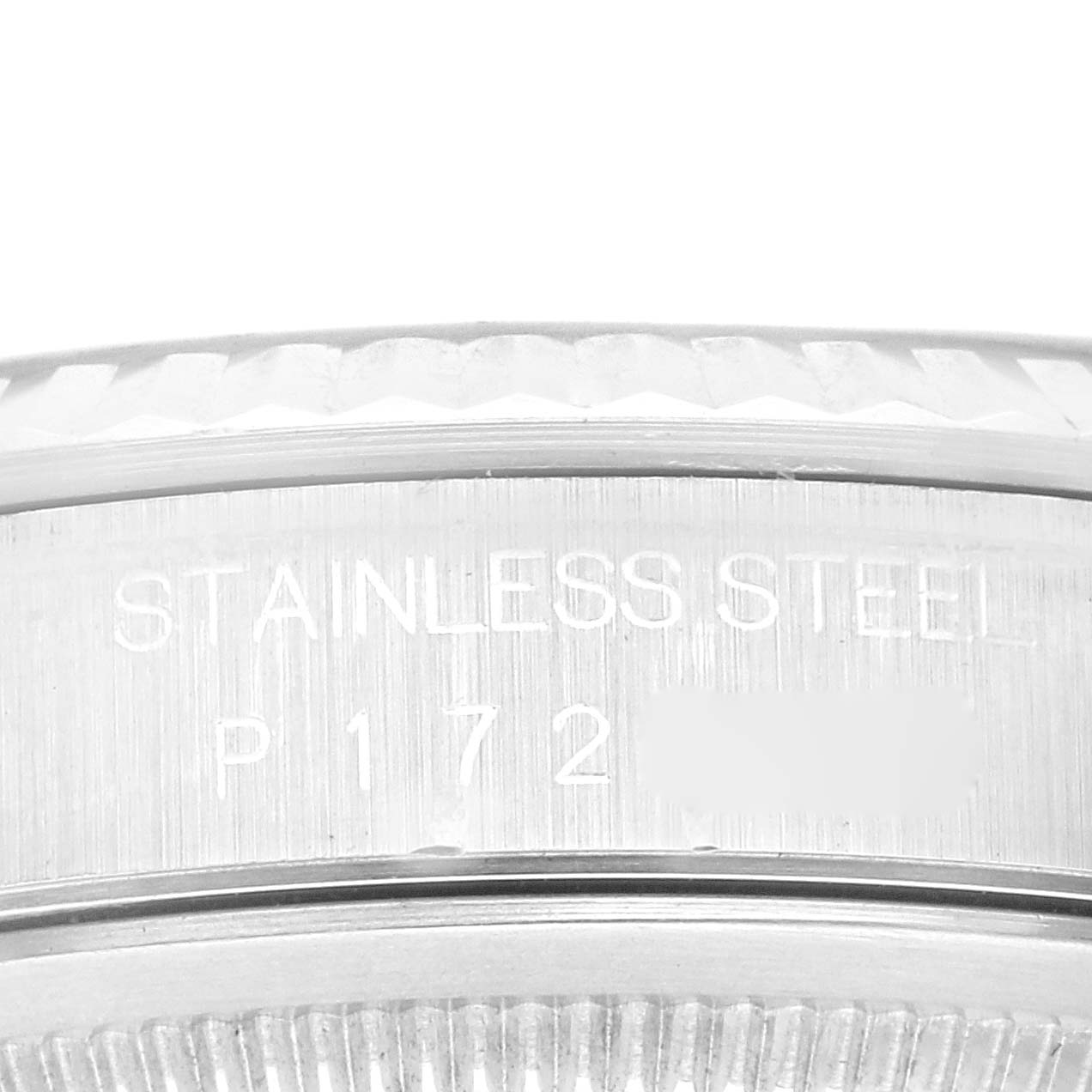 This image shows a close-up of the case back edge of a Rolex Datejust 16234G Men's Stainless Steel Blue Dial 16234G Men's Stainless Steel Blue Dial watch, highlighting the "STAINLESS STEEL" engraving.