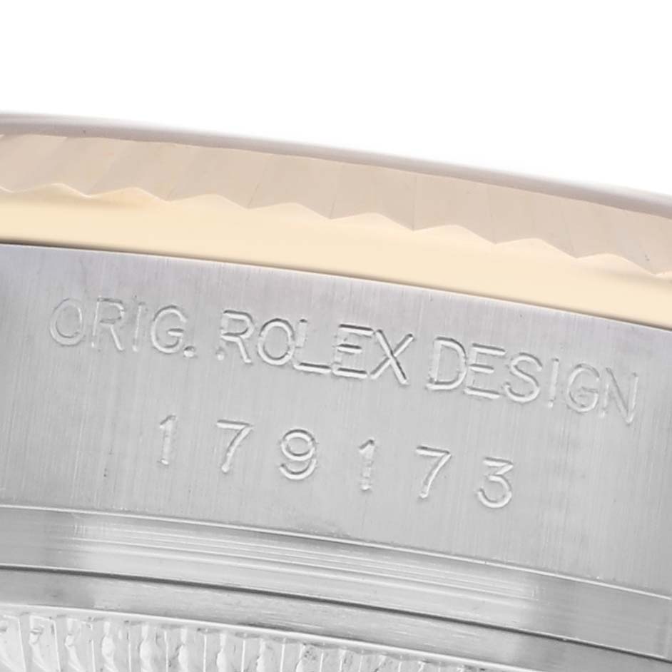 The image shows the side view of a Rolex Datejust 179173 Women
s Steel and Gold (two tone) Champagne Dial 179173 Women
s Steel and Gold (two tone) Champagne Dial case, highlighting the engraved model number.