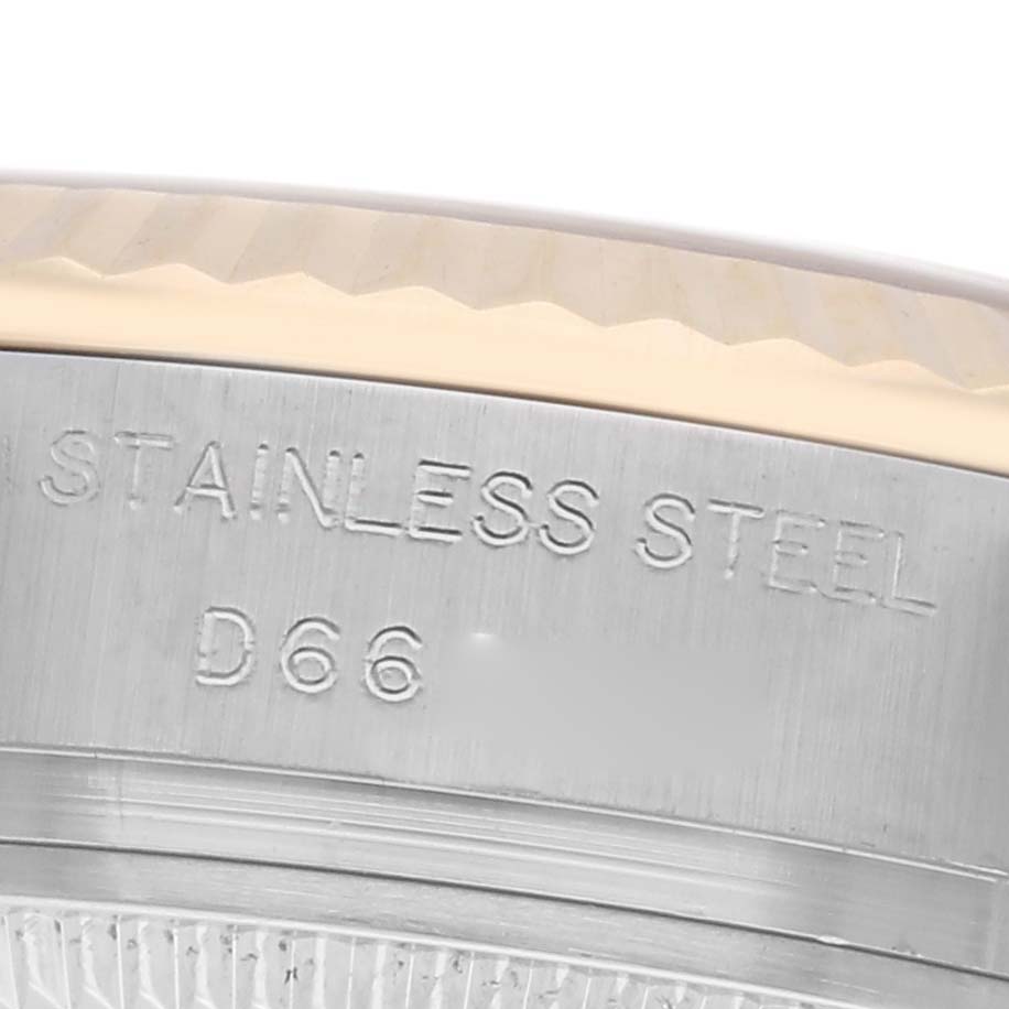 The image shows a close-up of the side of the Datejust by Rolex, highlighting the stainless steel material and serial engraving.