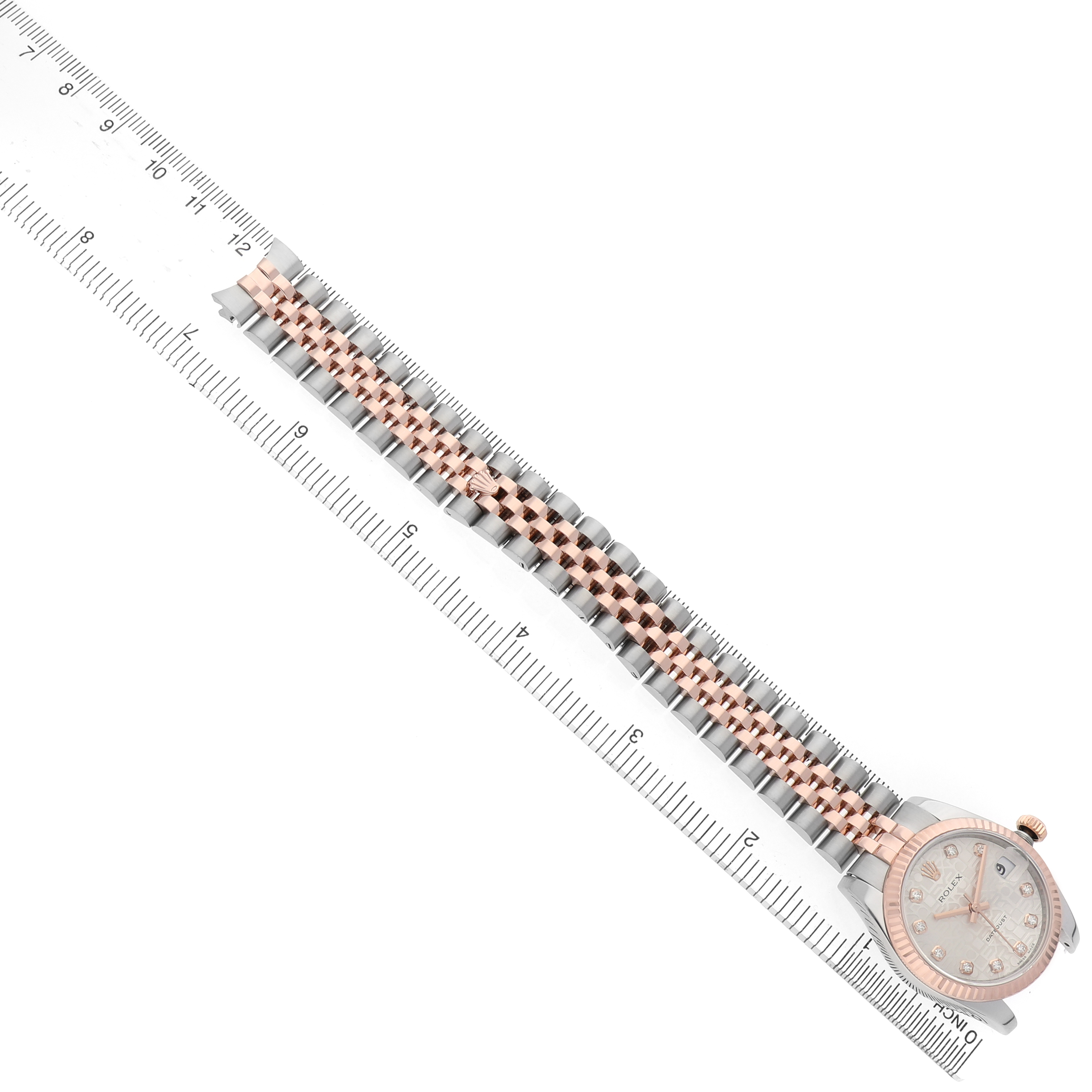 The Rolex Mid-Size 178271 Women's Stainless Steel Silver Dial watch is shown at a top-down angle, highlighting the full length of the bracelet alongside a measuring ruler.