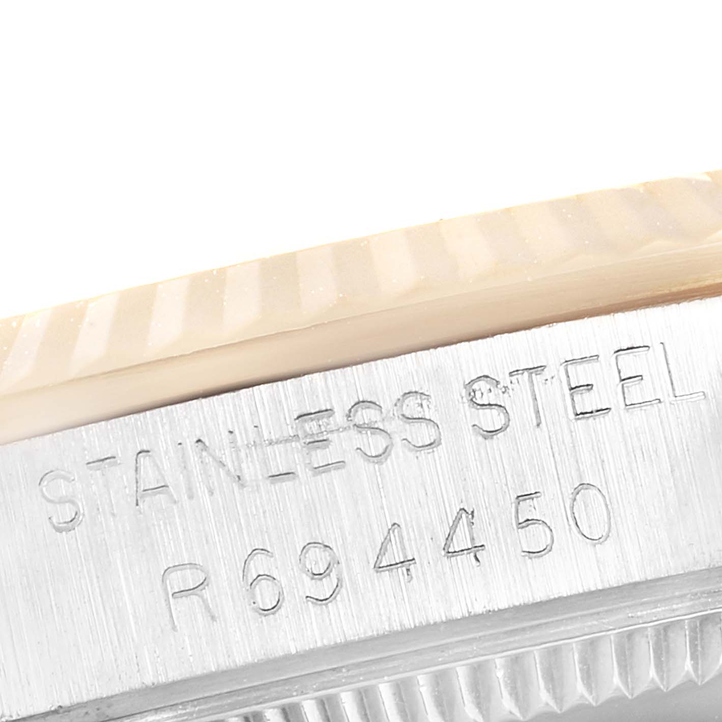 This image shows a close-up of the stainless steel engraved part and the fluted bezel of a Rolex Mid-Size 68273 Women
s Steel and Gold (two tone) Champagne Dial 68273 Women
s Steel and Gold (two tone) Champagne Dial model watch.