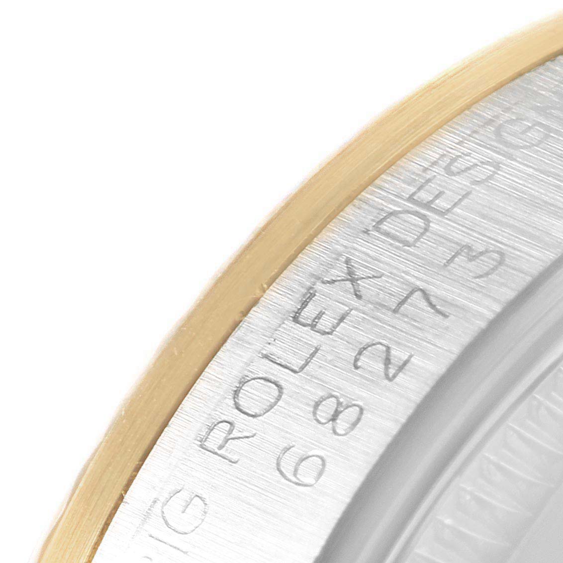 This image shows a close-up view of the rim and etched serial number on a Mid-Size Rolex watch.