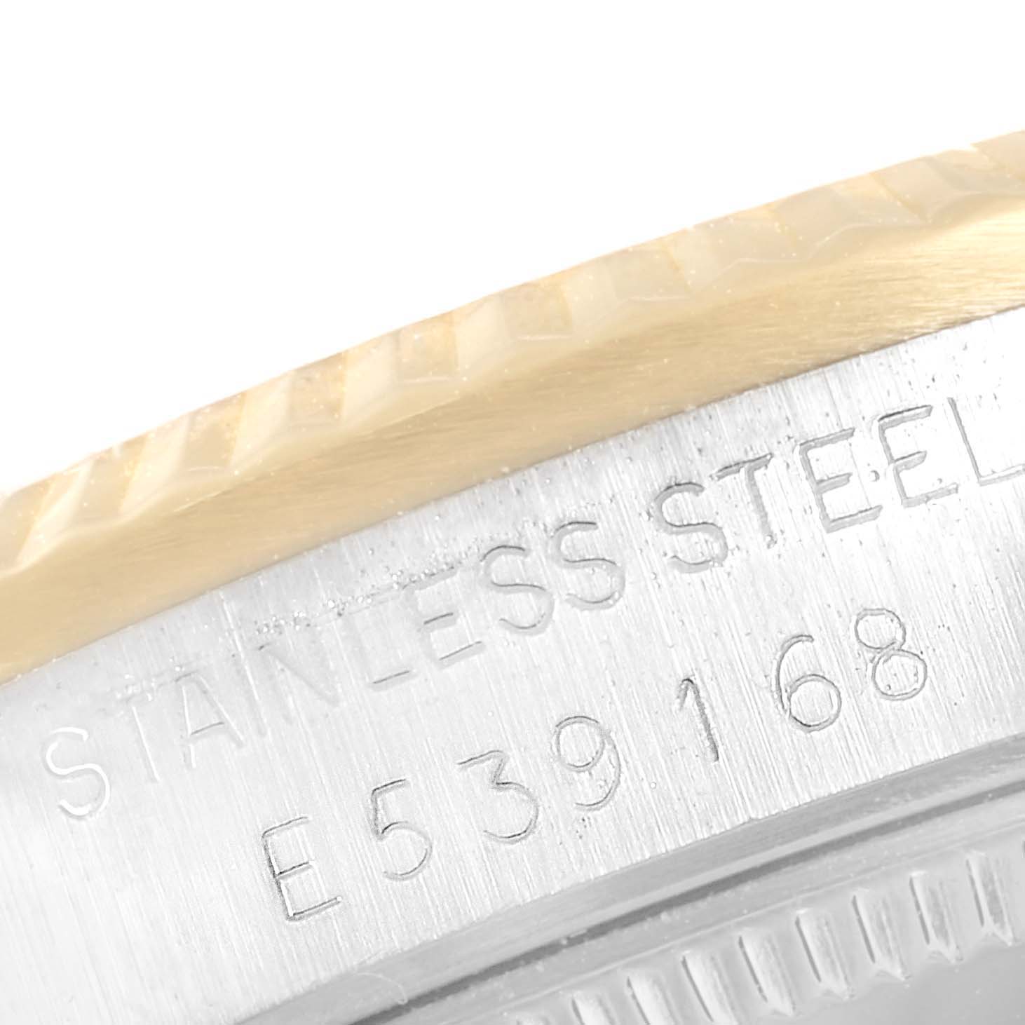 This image shows a close-up of the mid-size Rolex watch, highlighting the serial number engraving on the stainless steel case.