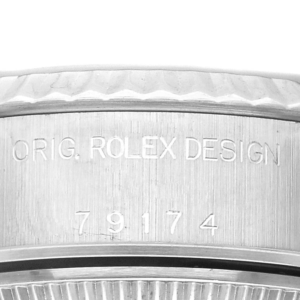 This image shows an angled close-up of the side of a Rolex Datejust 79174 Women's Stainless Steel Pink Dial 79174 Women's Stainless Steel Pink Dial watch, highlighting the "ORIG. ROLEX DESIGN" engraving and serial number.