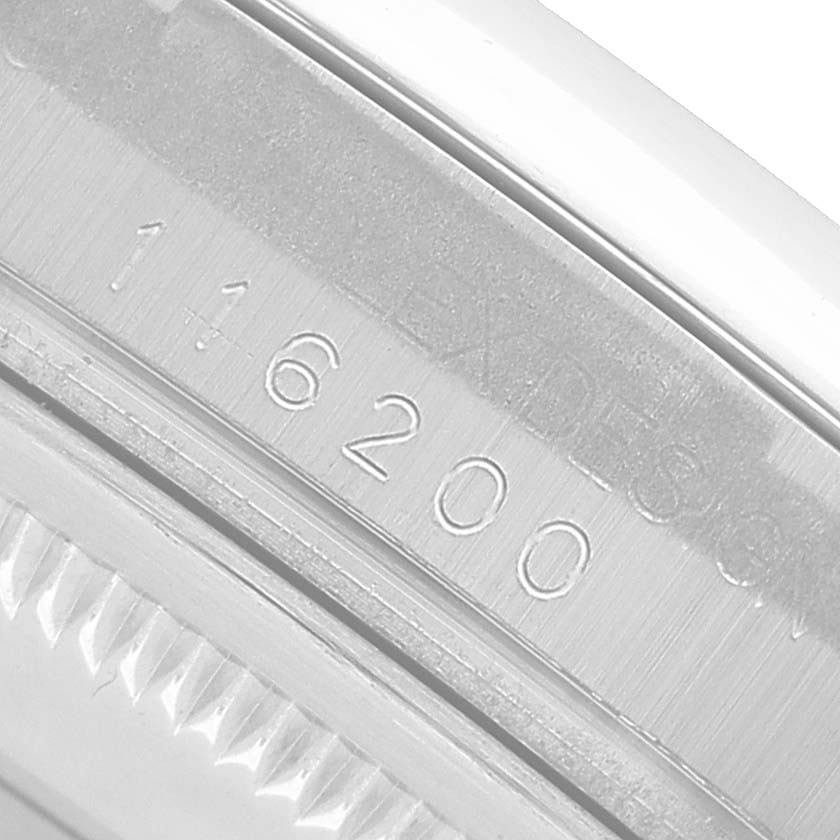 The image shows a close-up of the inner engraving on the bezel of a Rolex Datejust 116200 Men's Stainless Steel Black Dial watch.