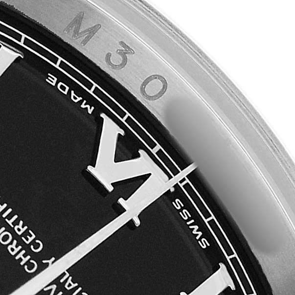 The image shows a close-up of the dial and bezel of a Rolex Datejust 116200 Men's Stainless Steel Black Dial, focusing on Roman numerals and markings.