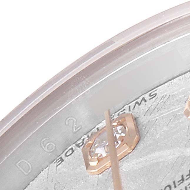 This is a close-up of a Rolex Datejust 179171 Women
s Steel and Gold (two tone) Silver Dial 179171 Women
s Steel and Gold (two tone) Silver Dial watch, highlighting a part of the dial with diamond indices and partial text.