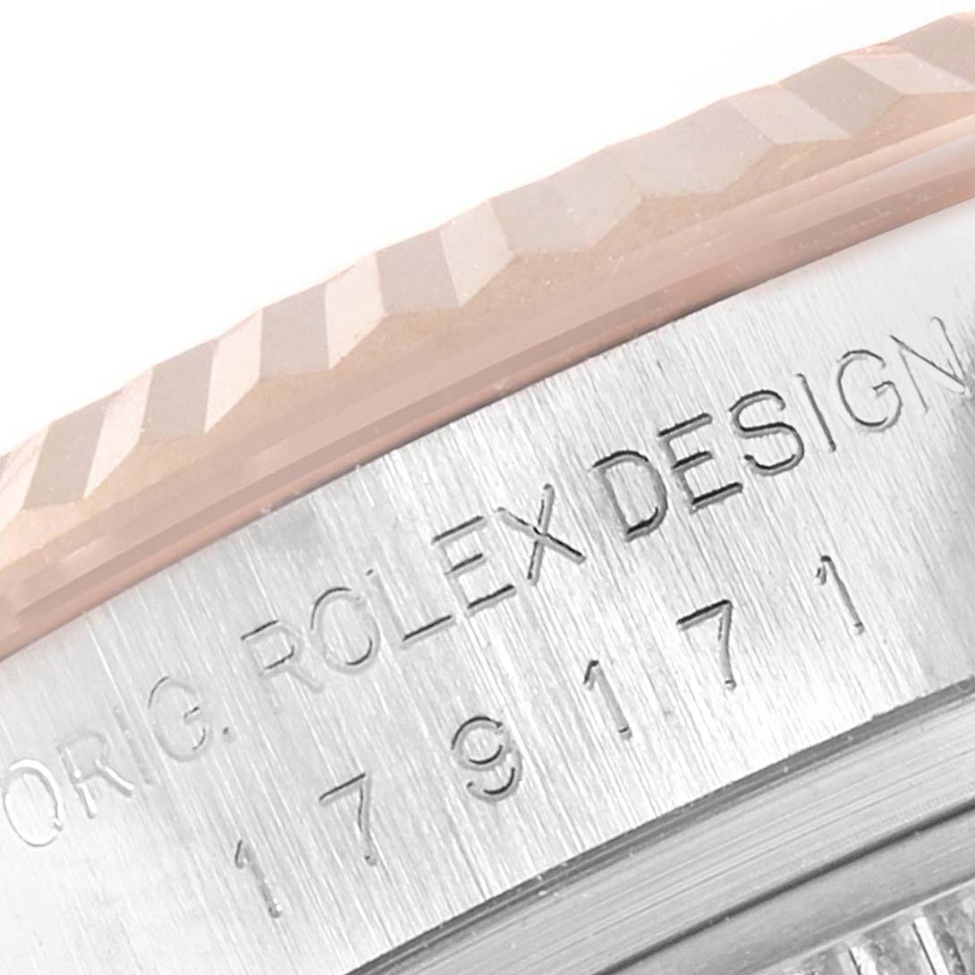 This close-up angle shows the fluted bezel and part of the engraved case of the Rolex Datejust 179171 Women
s Steel and Gold (two tone) Silver Dial 179171 Women
s Steel and Gold (two tone) Silver Dial model.