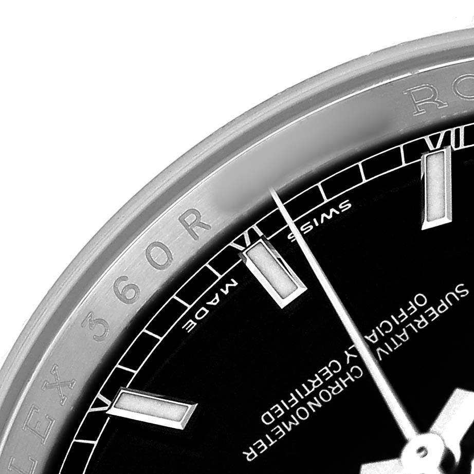The image shows a close-up of the bezel and part of the dial of a Rolex Datejust 116234 Men's Stainless Steel Black Dial, highlighting the hour markers and text on the watch face.