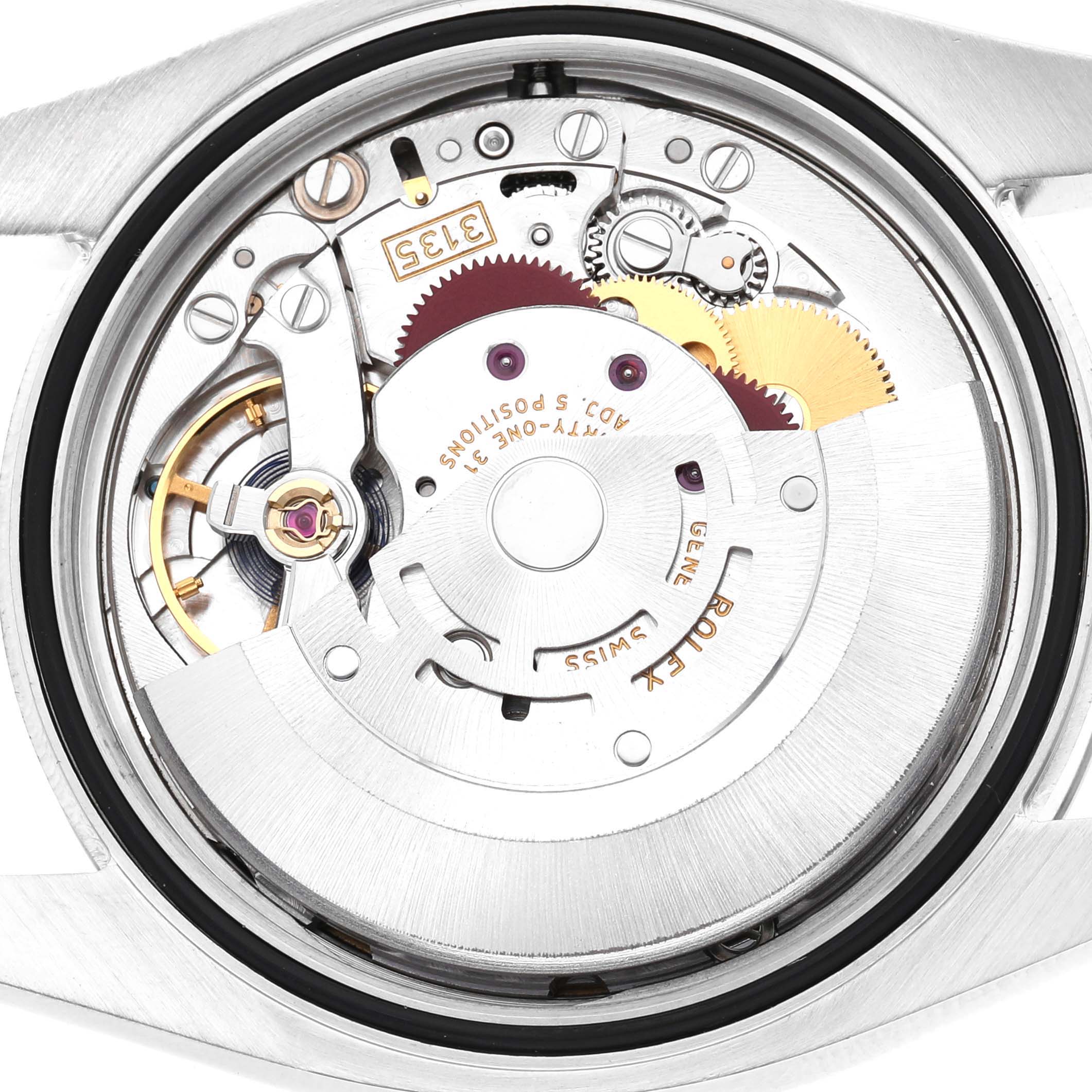 This image shows the internal movement of a Rolex Datejust 116234 Men's Stainless Steel Black Dial watch, focusing on the gears and rotor.