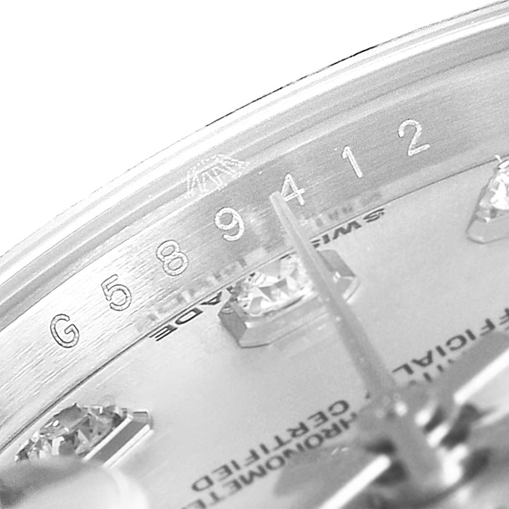 This close-up image of the Rolex Datejust 179174 Women
s Stainless Steel Silver Dial 179174 Women
s Stainless Steel Silver Dial watch shows the serial number, minute hand, and diamond indices on the dial.