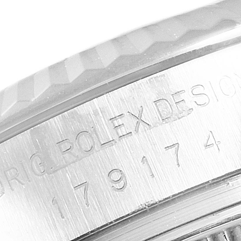 This image shows a close-up of the side case and bezel of a Rolex Datejust 179174 Women
s Stainless Steel Silver Dial 179174 Women
s Stainless Steel Silver Dial watch, highlighting its serial number engraving.