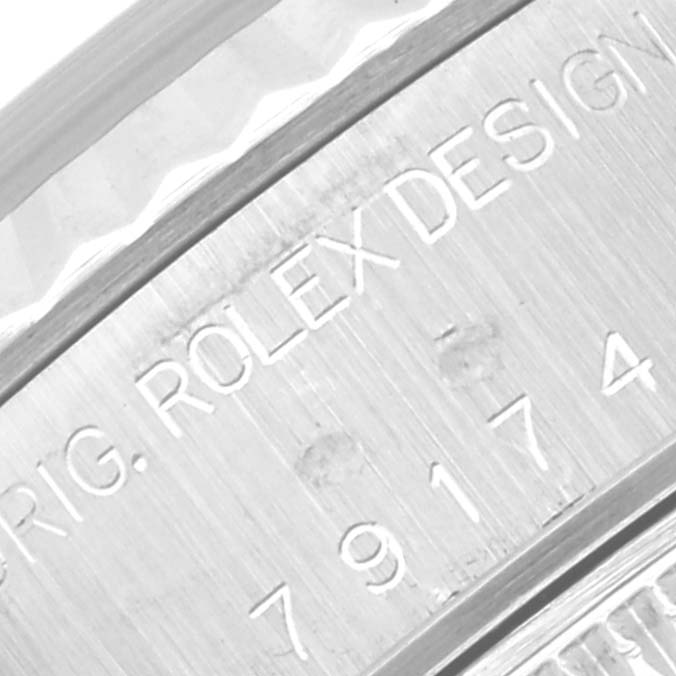 Close-up of the engraving on the side of a Rolex Datejust 79174 Women
s Stainless Steel Mother of Pearl Dial 79174 Women
s Stainless Steel Mother of Pearl Dial watch case, displaying the model number and the brand name.