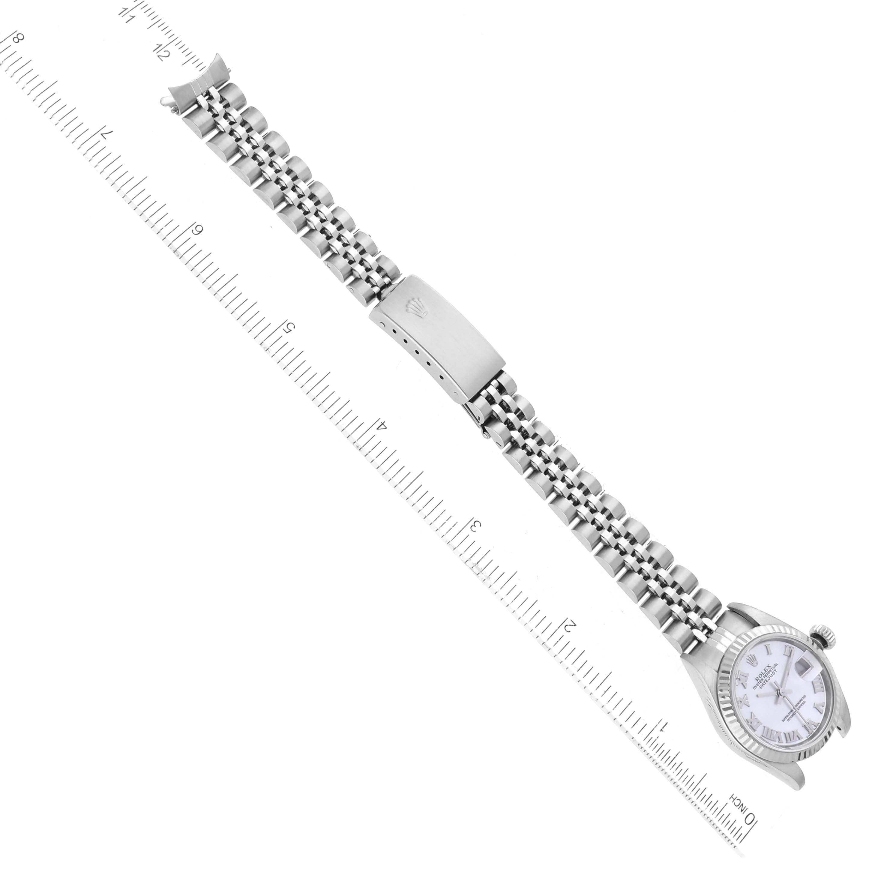 The image shows a Rolex Datejust 79174 Women
s Stainless Steel Mother of Pearl Dial 79174 Women
s Stainless Steel Mother of Pearl Dial watch laid flat and measured with a ruler, highlighting the face, bracelet, and clasp.
