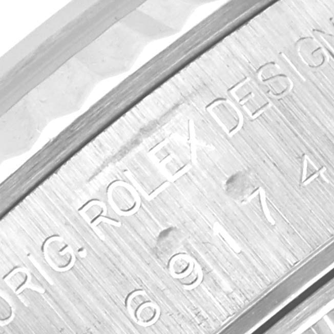 This close-up angle shows the engraved side of the Rolex Datejust 69174 Women's Stainless Steel White Dial 69174 Women's Stainless Steel White Dial watch case.