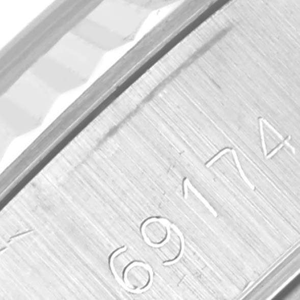 This close-up image shows the engraved model number of a Rolex Datejust 69174 Women
s Stainless Steel Silver Dial 69174 Women
s Stainless Steel Silver Dial watch.
