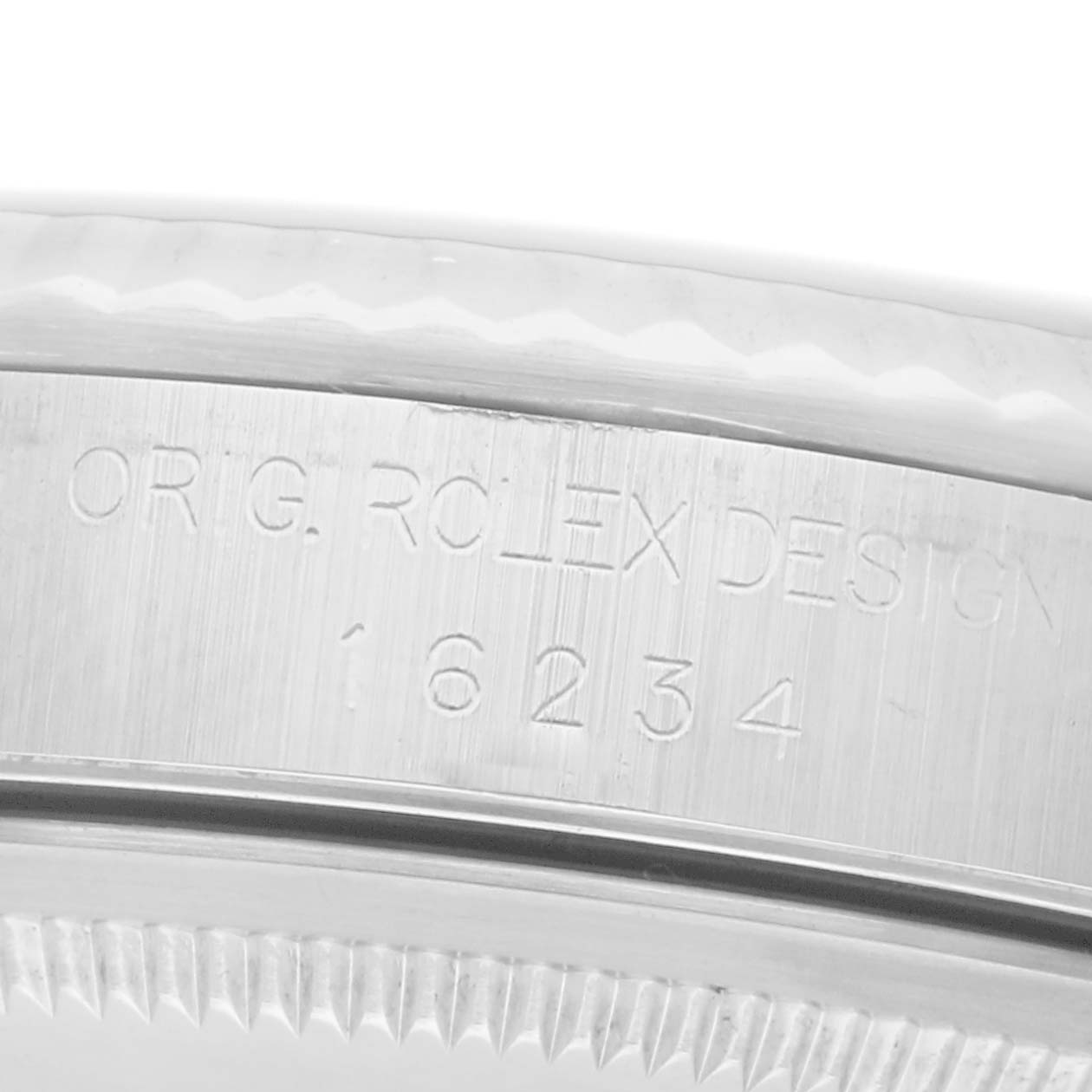The image shows a close-up of the side of a Rolex Datejust 16234 Men
s Steel and Gold (two tone) Silver Dial 16234 Men
s Steel and Gold (two tone) Silver Dial watch, featuring the engraved serial number and "ORIG. ROLEX DESIGN."