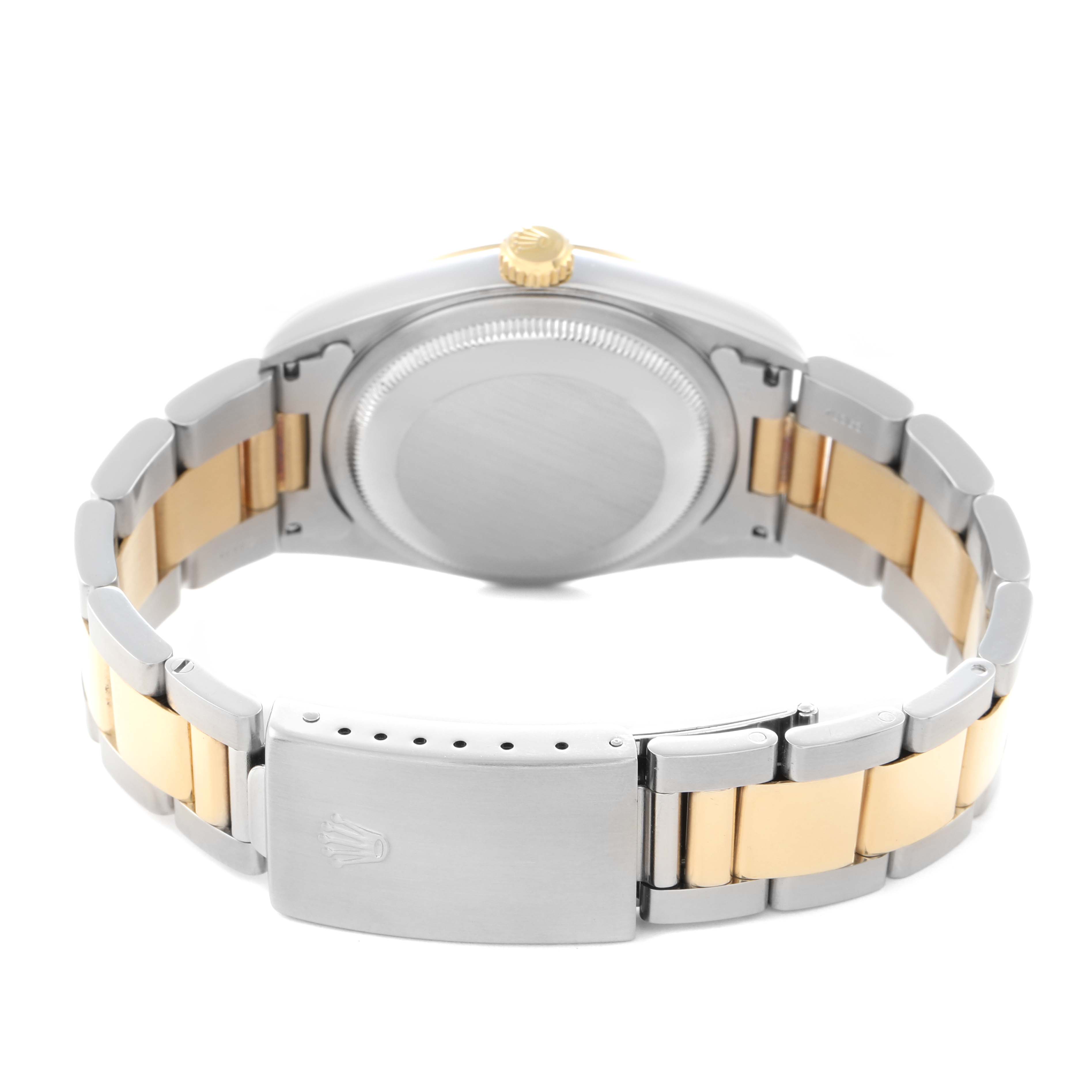 The image shows the back of a Rolex Datejust 16203 Men
s Steel and Gold (two tone) Champagne Dial 16203 Men
s Steel and Gold (two tone) Champagne Dial watch at an angle highlighting the case, crown, and two-tone bracelet with clasp.