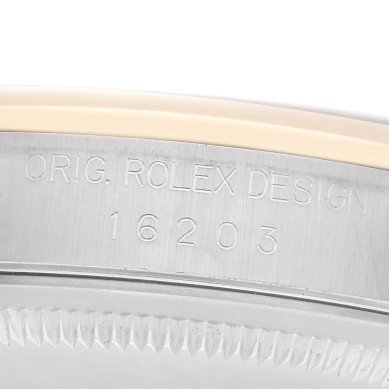 The image shows the engraved side of a Rolex Datejust 16203 Men
s Steel and Gold (two tone) Champagne Dial 16203 Men
s Steel and Gold (two tone) Champagne Dial, highlighting the model number and design inscription.
