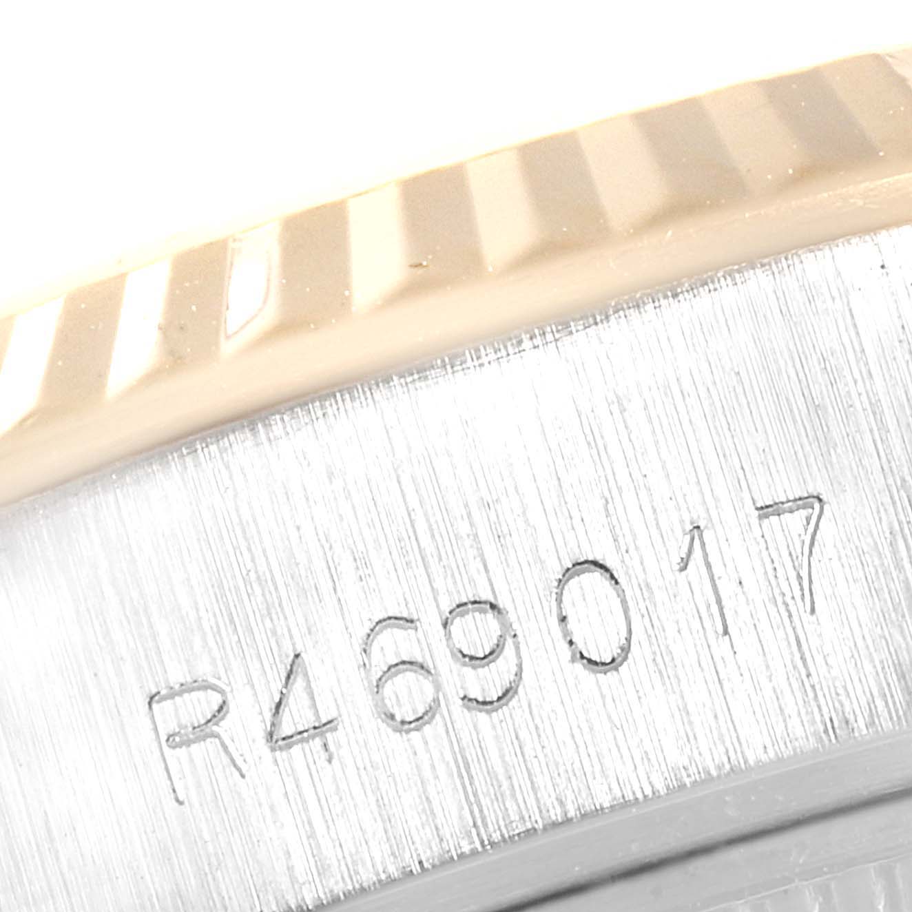 This close-up image shows the serial number and part of the fluted bezel of a Rolex Datejust 69173 Women
s Steel and Gold (two tone) Champagne Dial 69173 Women
s Steel and Gold (two tone) Champagne Dial watch.