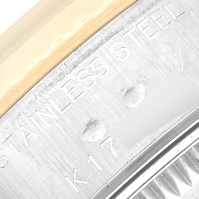 The image shows a close-up of the stainless steel caseback and edge of the bezel of a Rolex Datejust 79173 Women
s Steel and Gold (two tone) Mother of Pearl Dial 79173 Women
s Steel and Gold (two tone) Mother of Pearl Dial watch.