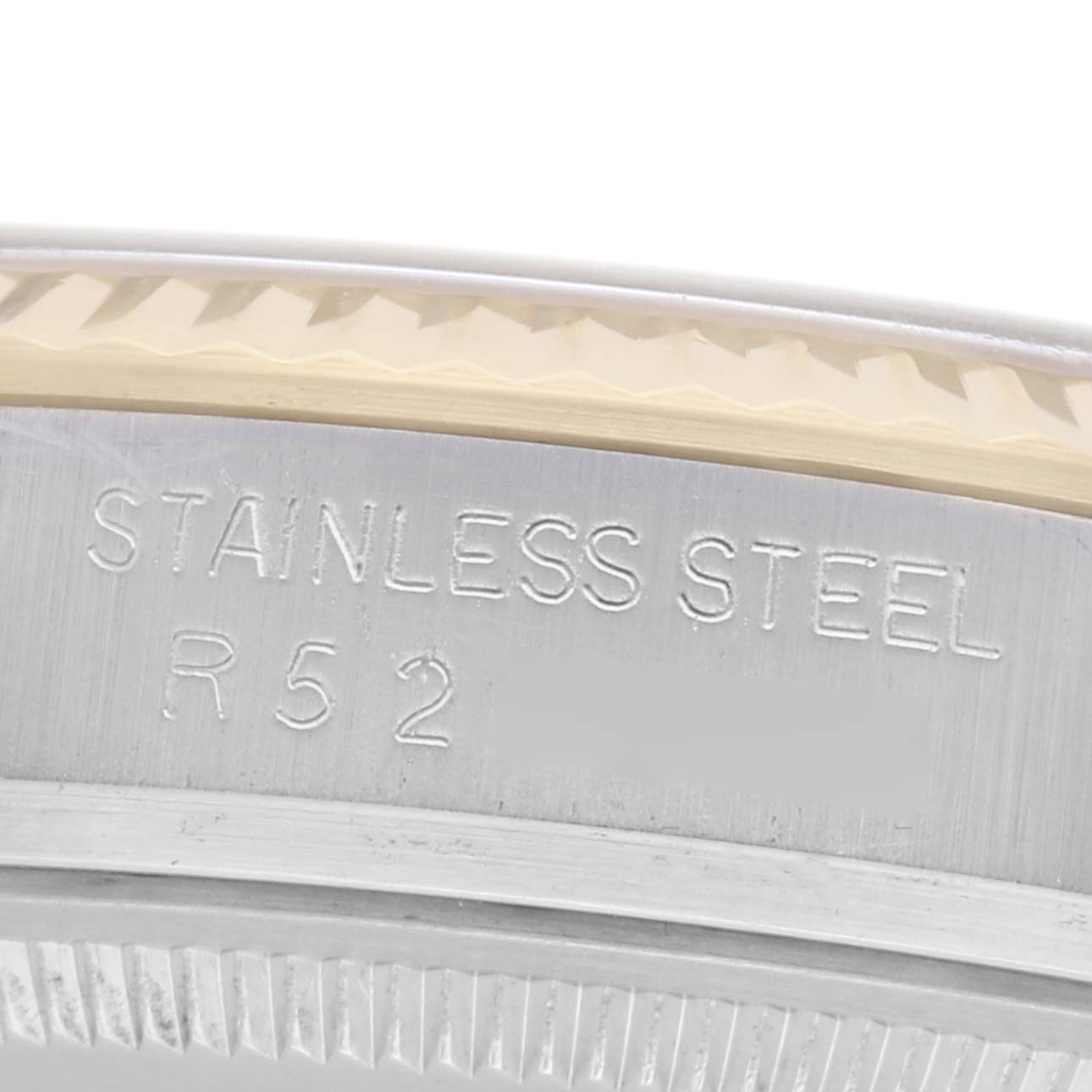 This close-up image shows the bezel edge and stamped details of a Rolex Datejust 16013 Men
s Steel and Gold (two tone) Champagne Dial 16013 Men
s Steel and Gold (two tone) Champagne Dial watch case.