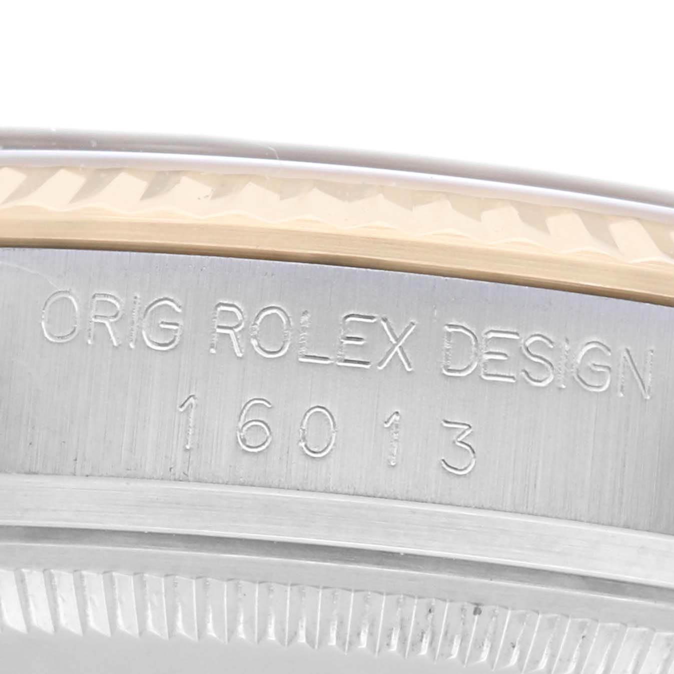 The image shows a close-up of the engraved side of a Rolex Datejust 16013 Men
s Steel and Gold (two tone) Champagne Dial 16013 Men
s Steel and Gold (two tone) Champagne Dial model, highlighting the case design and model number.