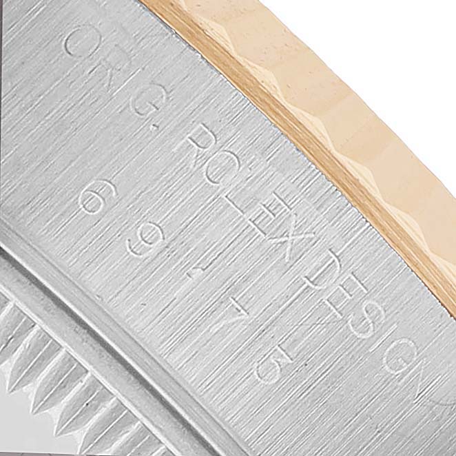 The image shows a close-up of the case side of a Rolex Datejust 69173 Women's Steel and Gold (two tone) White Dial, featuring engraved model details.