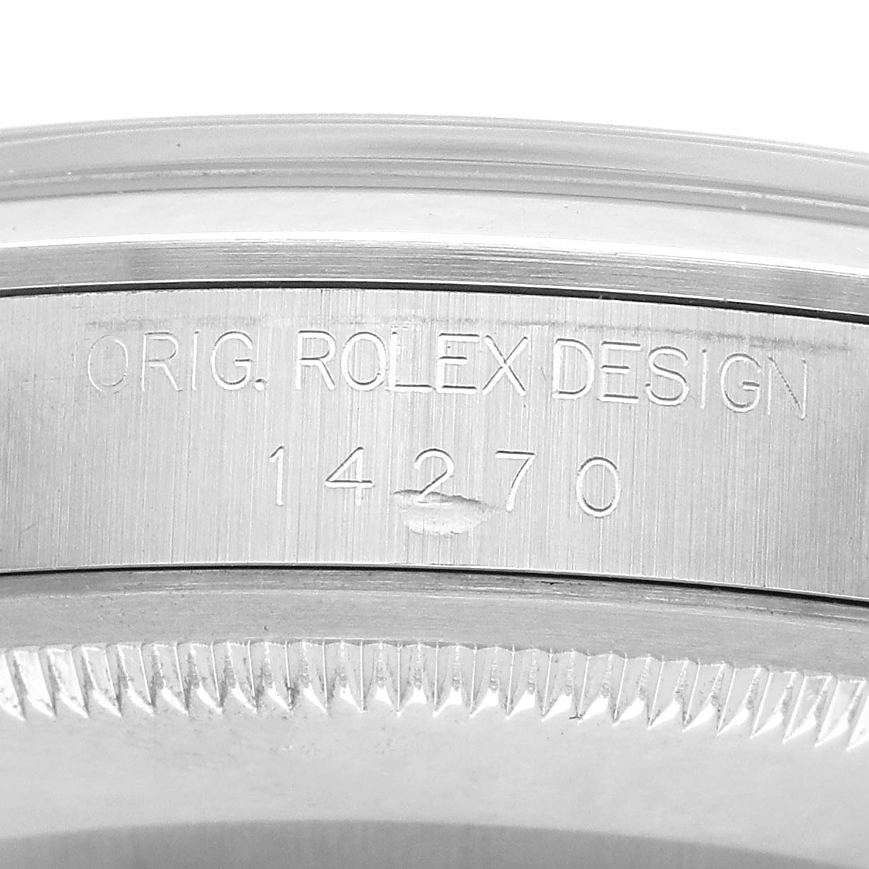 This image shows the case side of a Rolex Explorer 14270 Men's Stainless Steel Black Dial, featuring its engraved serial and design numbers.