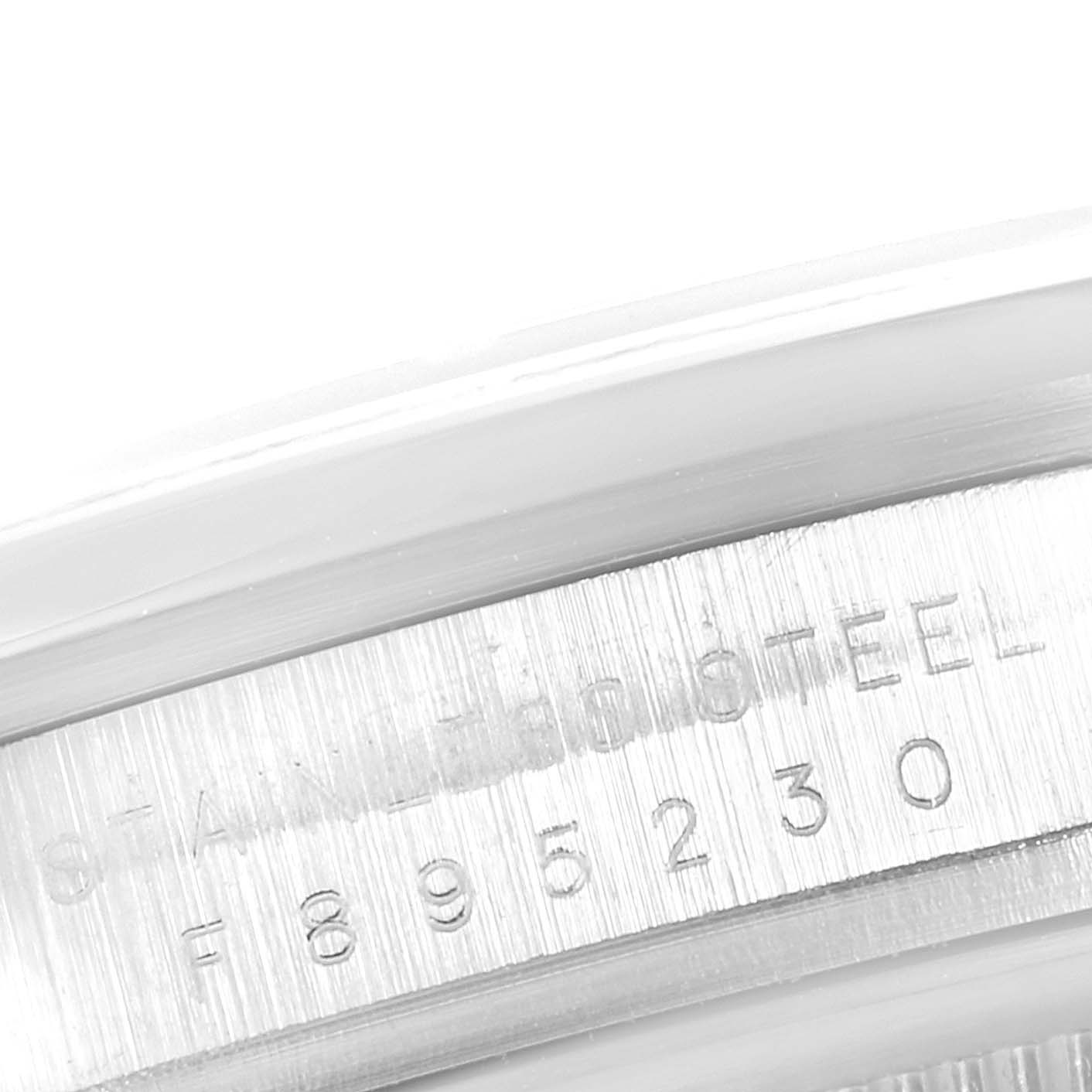 This image shows a close-up of the serial number and "STAINLESS STEEL" engraving on the rim of the Rolex Explorer 114270 Men
s Stainless Steel Black Dial 114270 Men
s Stainless Steel Black Dial watch casing.