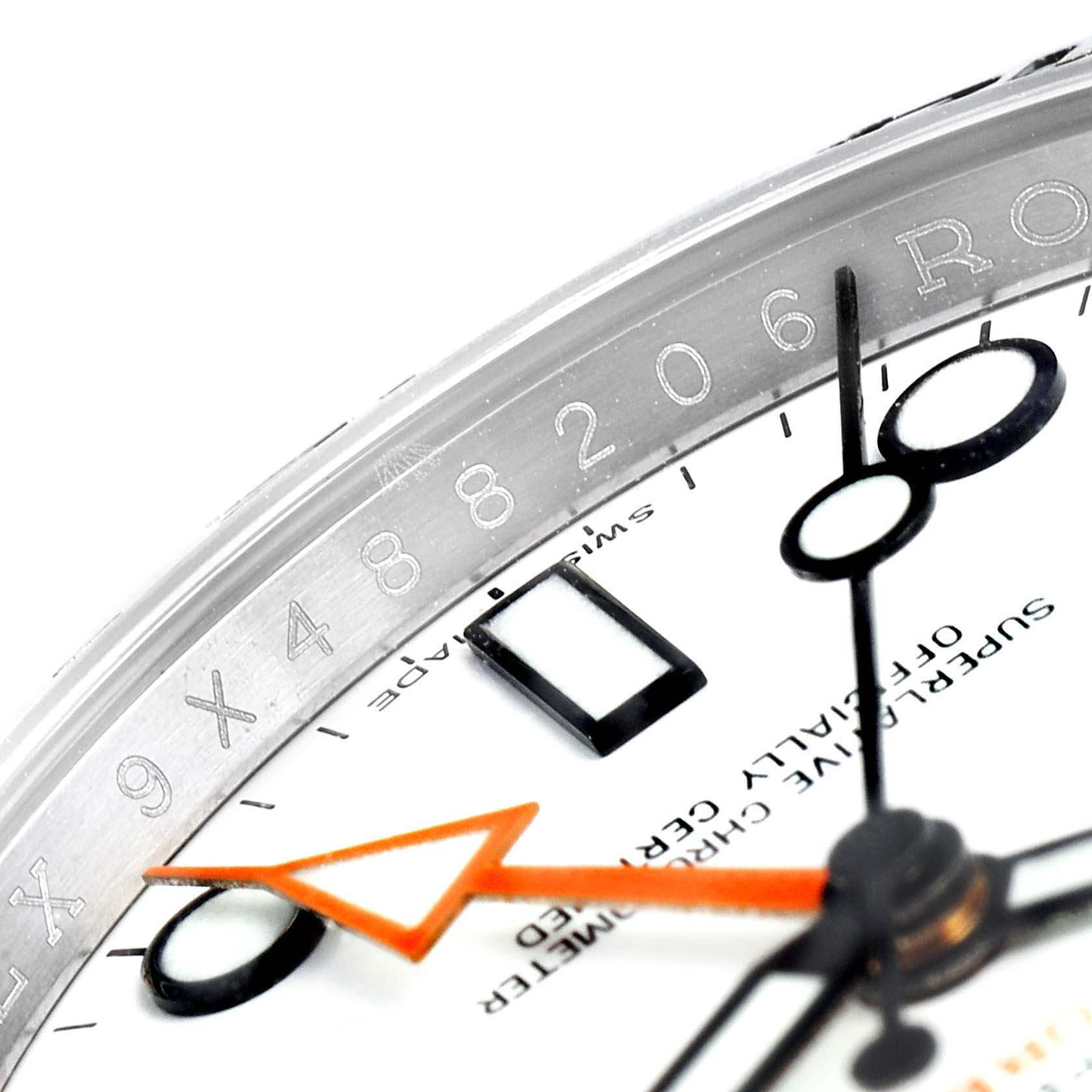 This image shows a close-up of the dial, bezel, and serial number of a Rolex Explorer 216570 Men's Stainless Steel White Dial 216570 Men's Stainless Steel White Dial watch.
