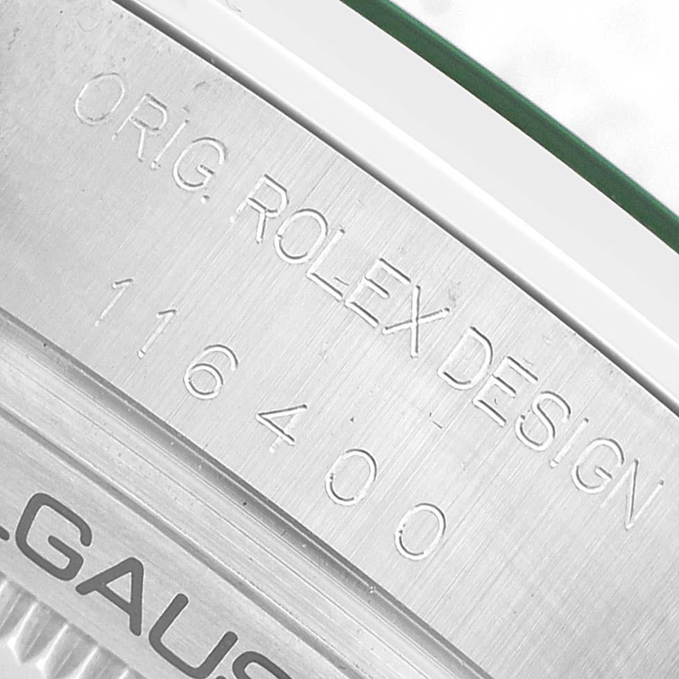 The image shows a close-up of the Rolex Milgauss 116400GV Men's Stainless Steel Blue Dial model's engraved polished case with model and design details.