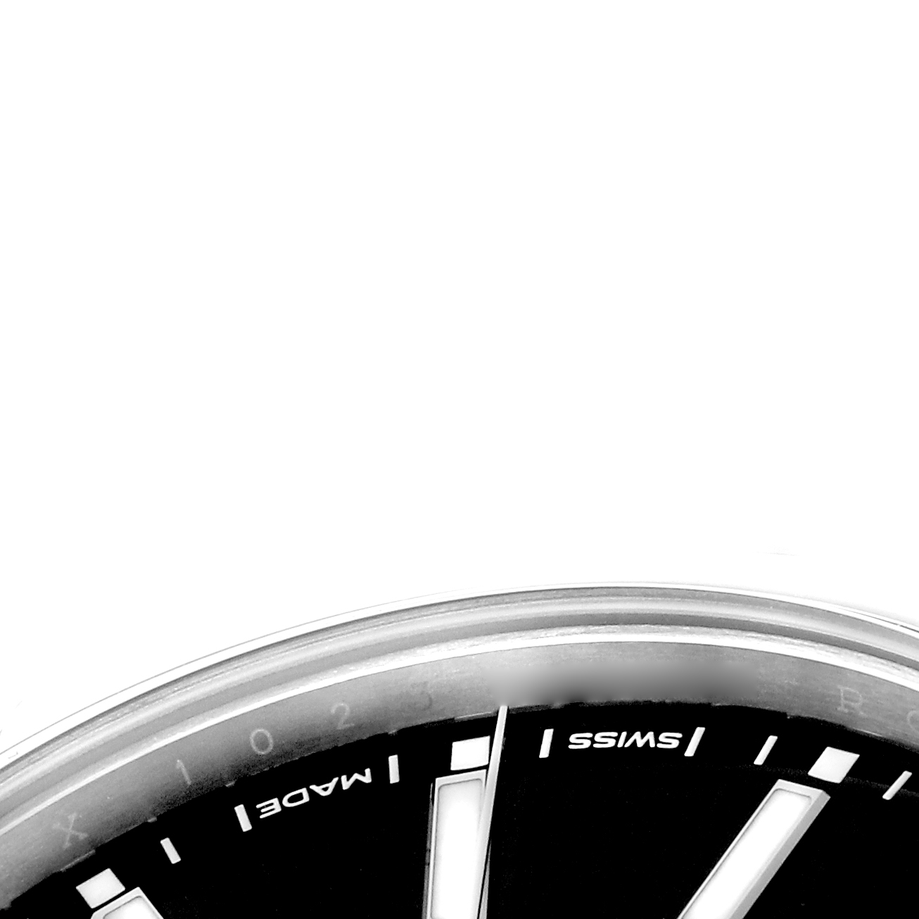 The image shows a close-up of the dial edge of a Rolex Oyster Perpetual 114300 Men
s Stainless Steel Black Dial 114300 Men
s Stainless Steel Black Dial, highlighting the "SWISS MADE" text and hour markers.