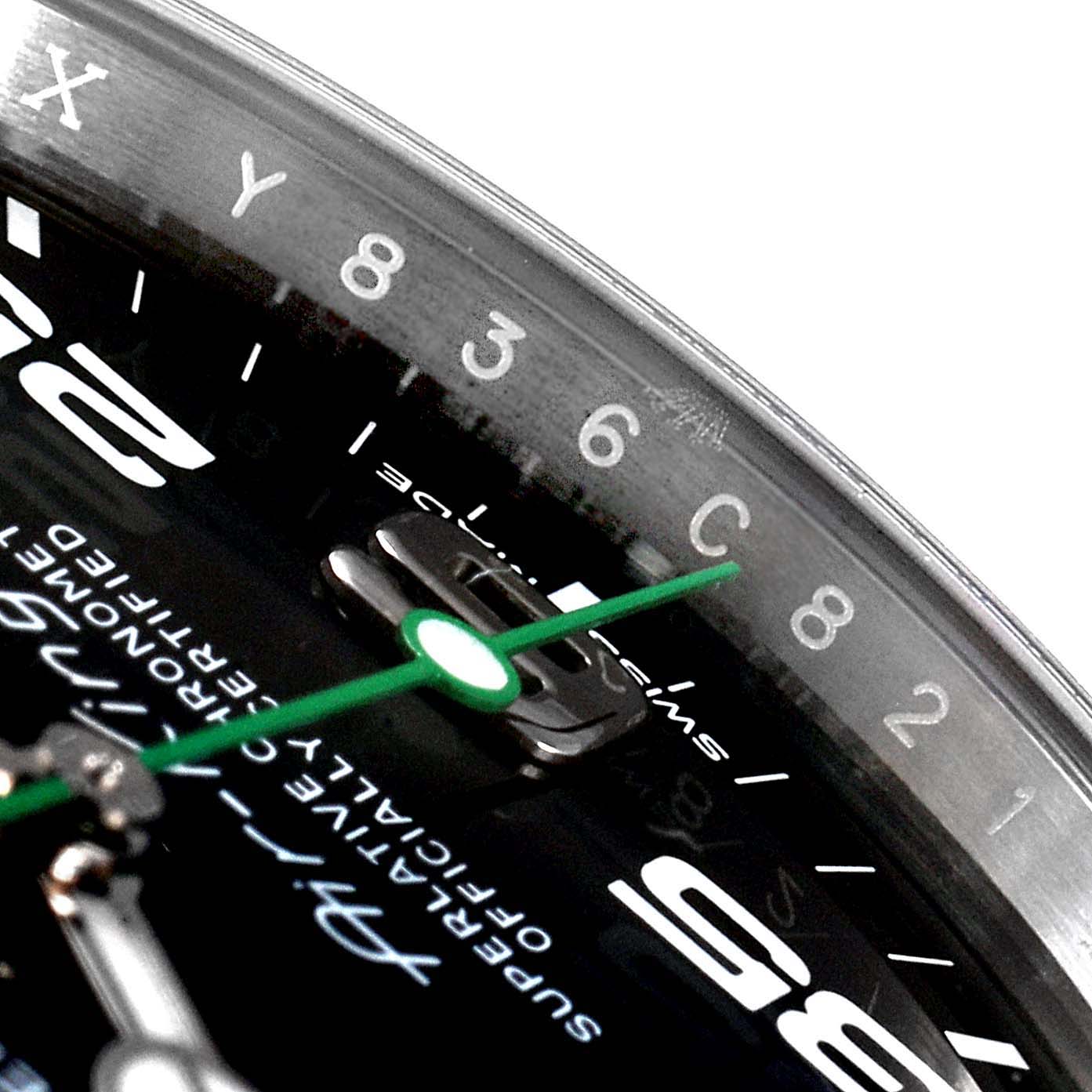 The image shows a close-up, partial view of the dial and green second hand of the Rolex Air-King 116900 Men's Stainless Steel Black Dial 116900 Men's Stainless Steel Black Dial watch.
