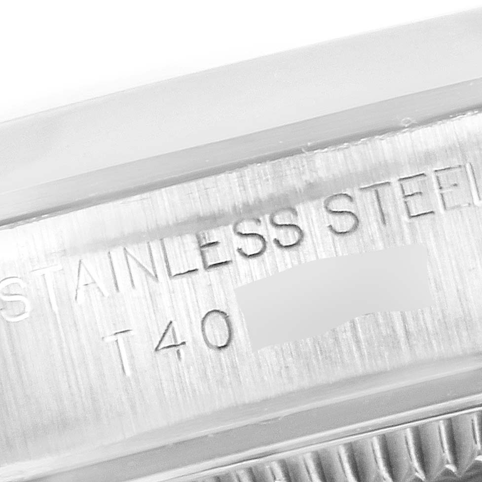 The image shows a close-up of the stainless steel engraving on the case of a Rolex Oyster Perpetual 67180 Women's Stainless Steel Pink Dial 67180 Women's Stainless Steel Pink Dial watch.