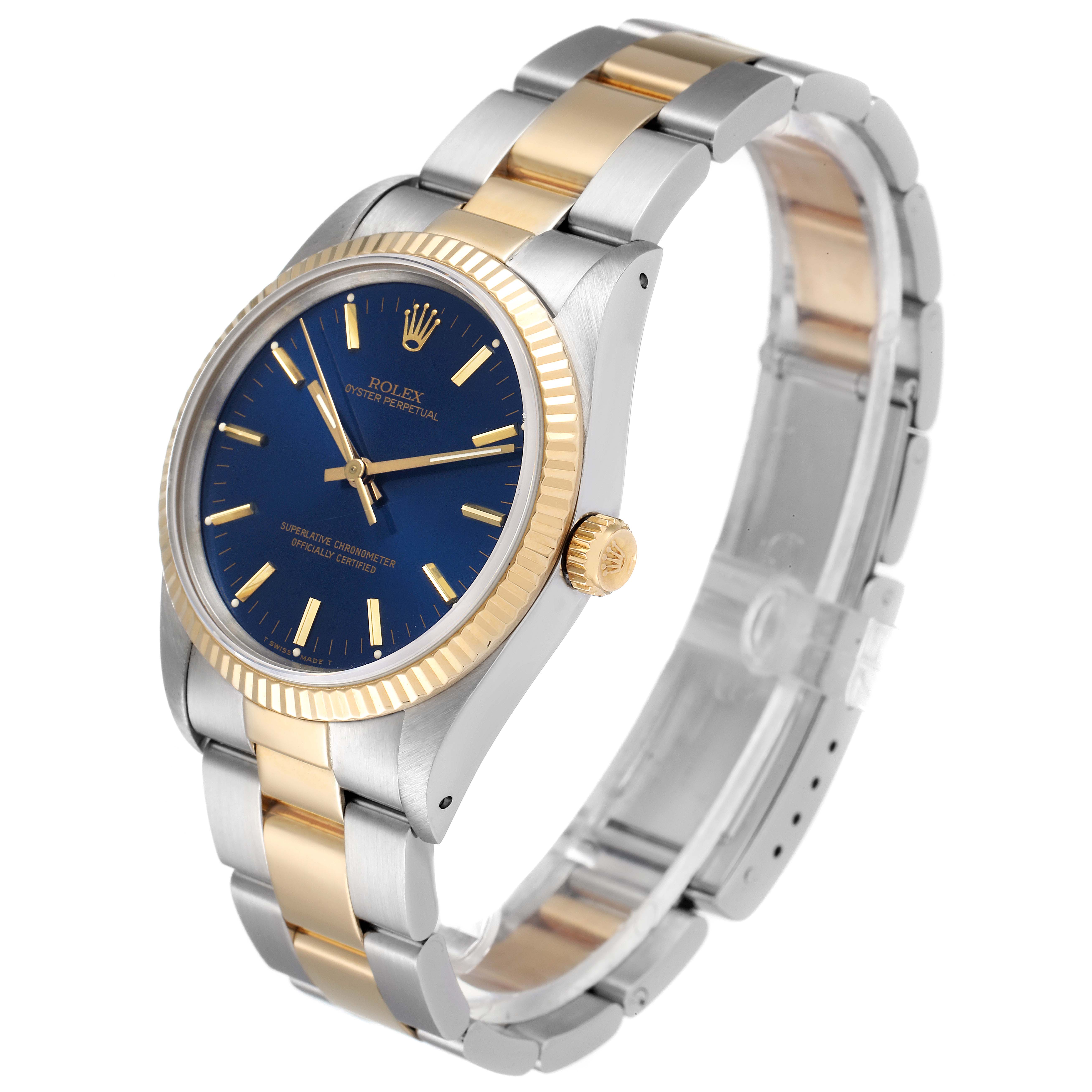 The image shows a Rolex Oyster Perpetual 14233 Men's Steel and Gold (two tone) Blue Dial 14233 Men's Steel and Gold (two tone) Blue Dial watch at a three-quarter angle, emphasizing its blue dial and two-tone metal bracelet.