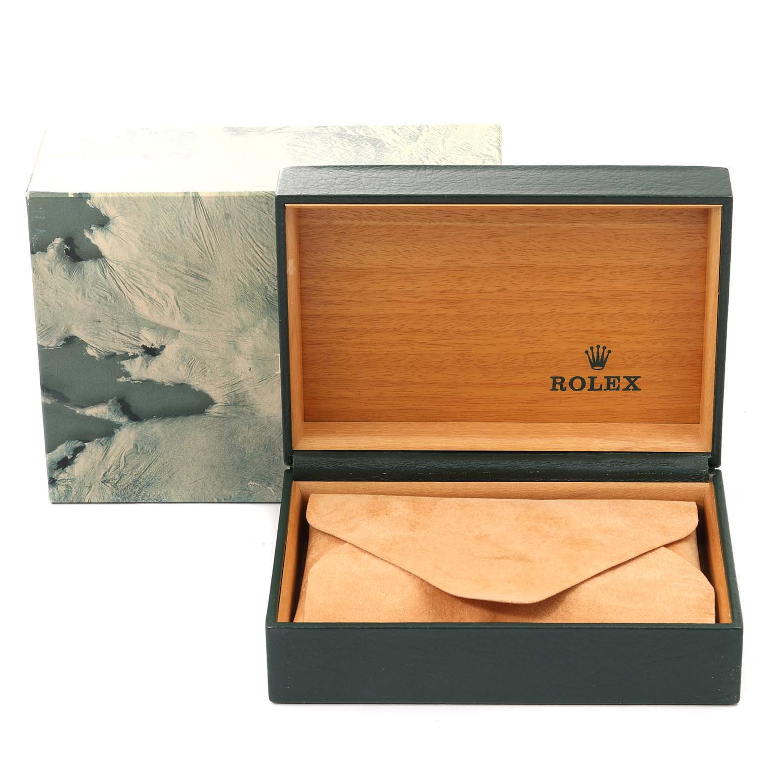 This image shows an open Rolex box for the Oyster Perpetual model, featuring wood interior and a suede pouch inside.