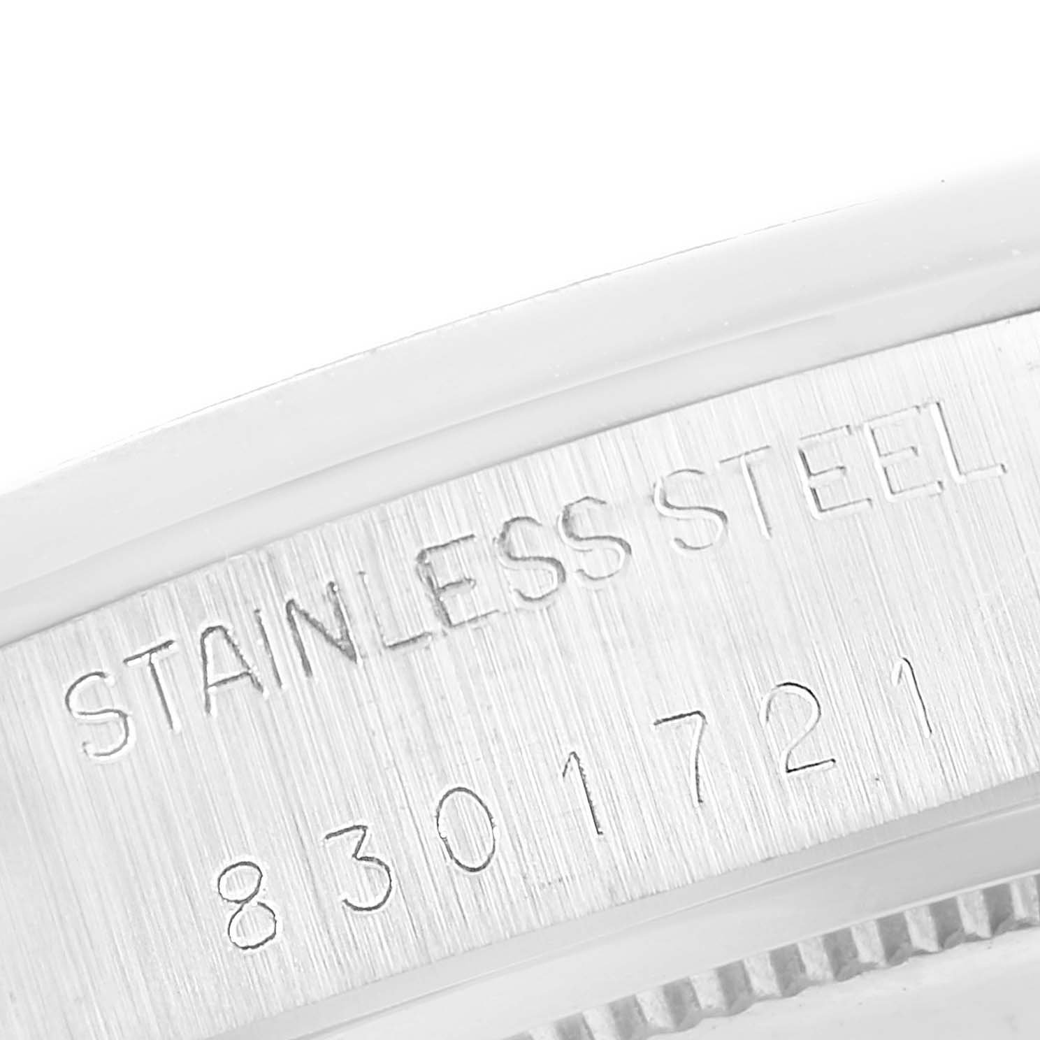 This close-up image shows the engraved stainless steel part of a Vintage Collection Rolex watch, including its serial number.