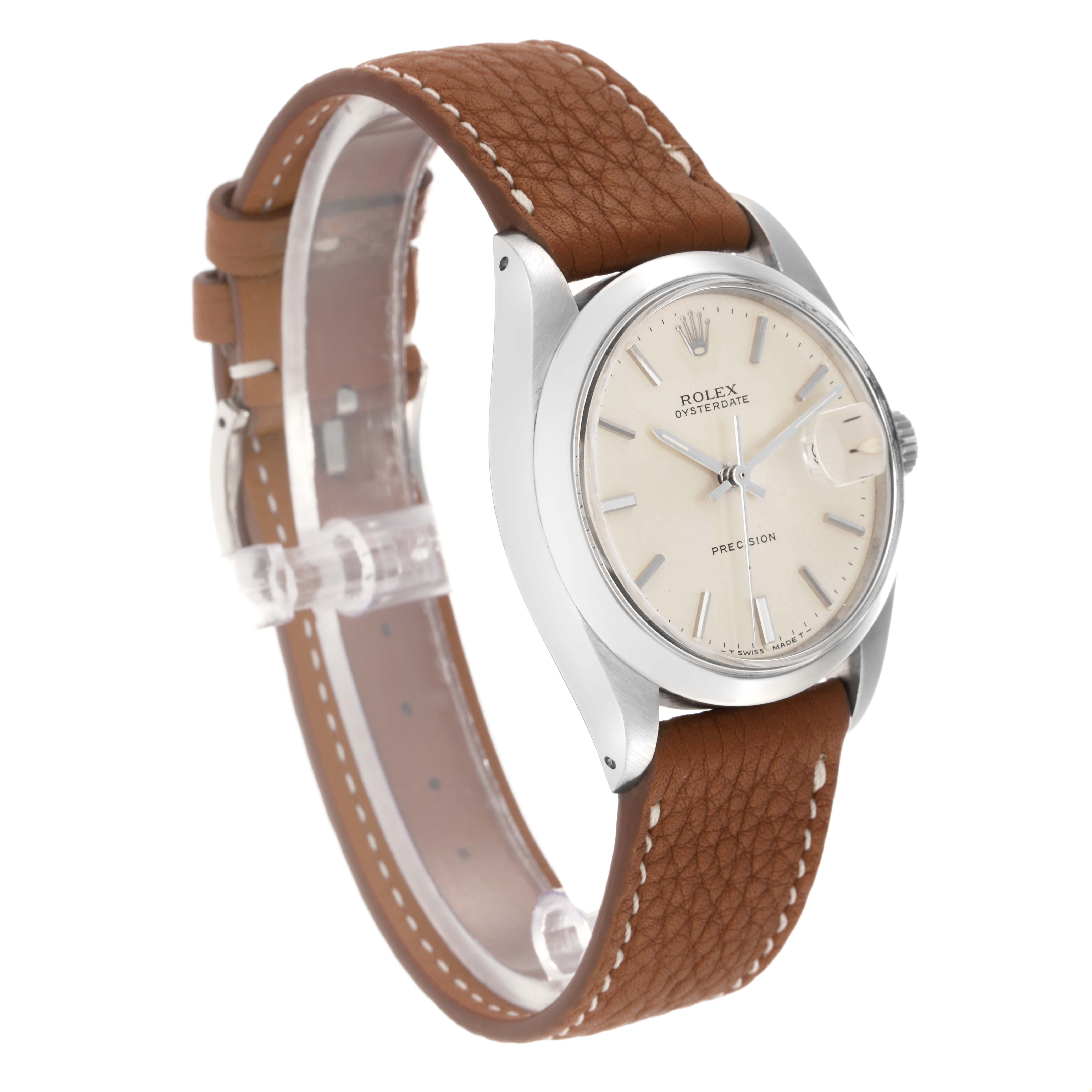 The Rolex Date 6694 Men
s Stainless Steel Silver Dial 6694 Men
s Stainless Steel Silver Dial watch is shown at a three-quarter angle, highlighting the dial, bezel, and brown leather strap.