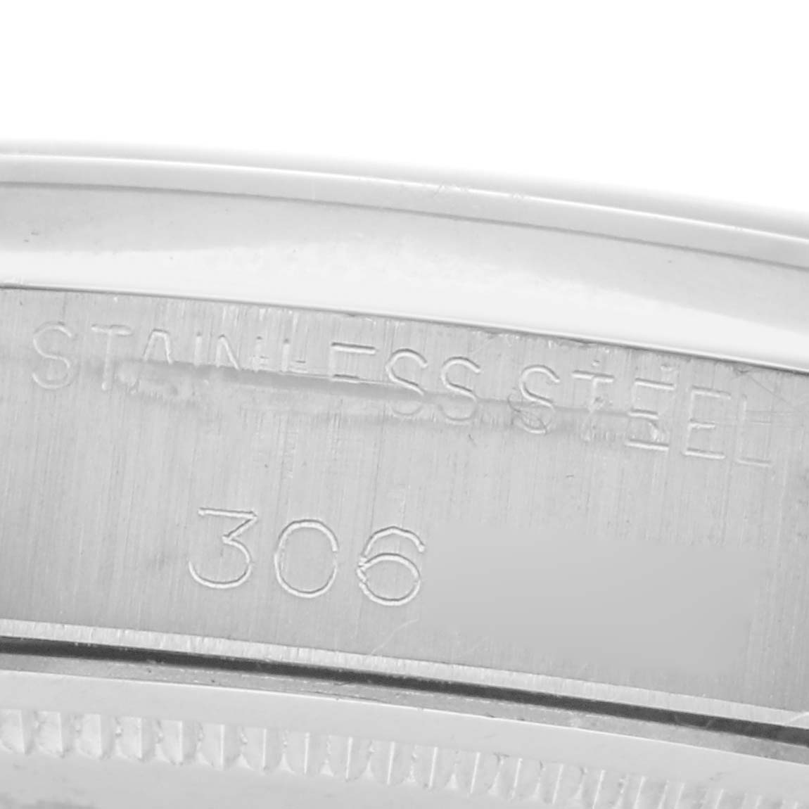 The image shows a close-up of the bezel edge and inner engraving of a Rolex Date 6694 Men
s Stainless Steel Silver Dial 6694 Men
s Stainless Steel Silver Dial watch, highlighting "STAINLESS STEEL" and "306".