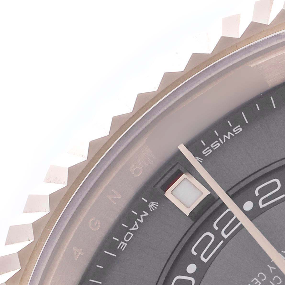 The image shows a close-up of the Rolex Sky-Dweller 336235 Men
s Rose Gold Grey Dial 336235 Men
s Rose Gold Grey Dial watch featuring the bezel, part of the dial, and hour markings.