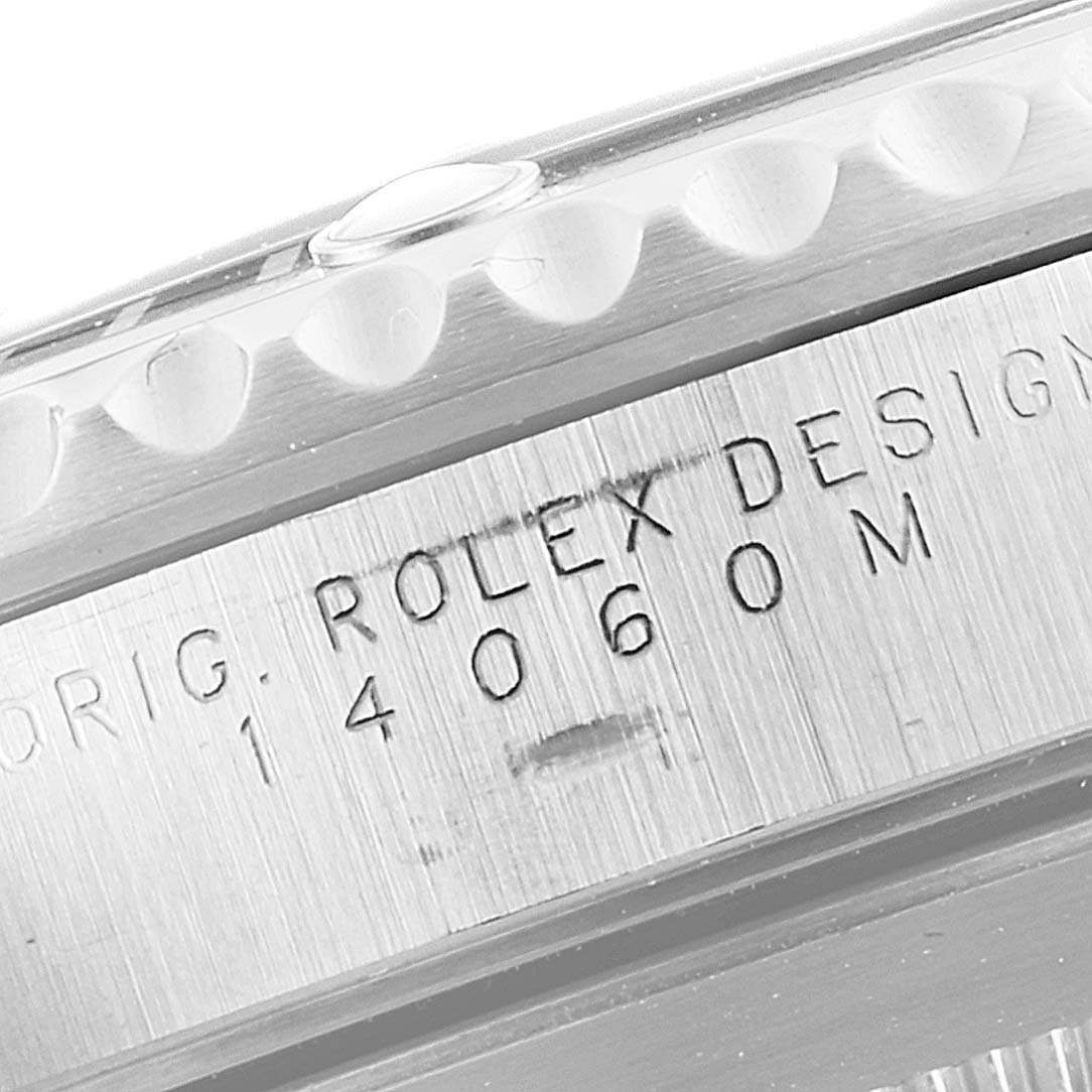This close-up image shows the side casing of a Rolex Submariner 14060 Men
s Stainless Steel Black Dial 14060 Men
s Stainless Steel Black Dial watch with the model number and 
ROLEX DESIGN
 engraved.