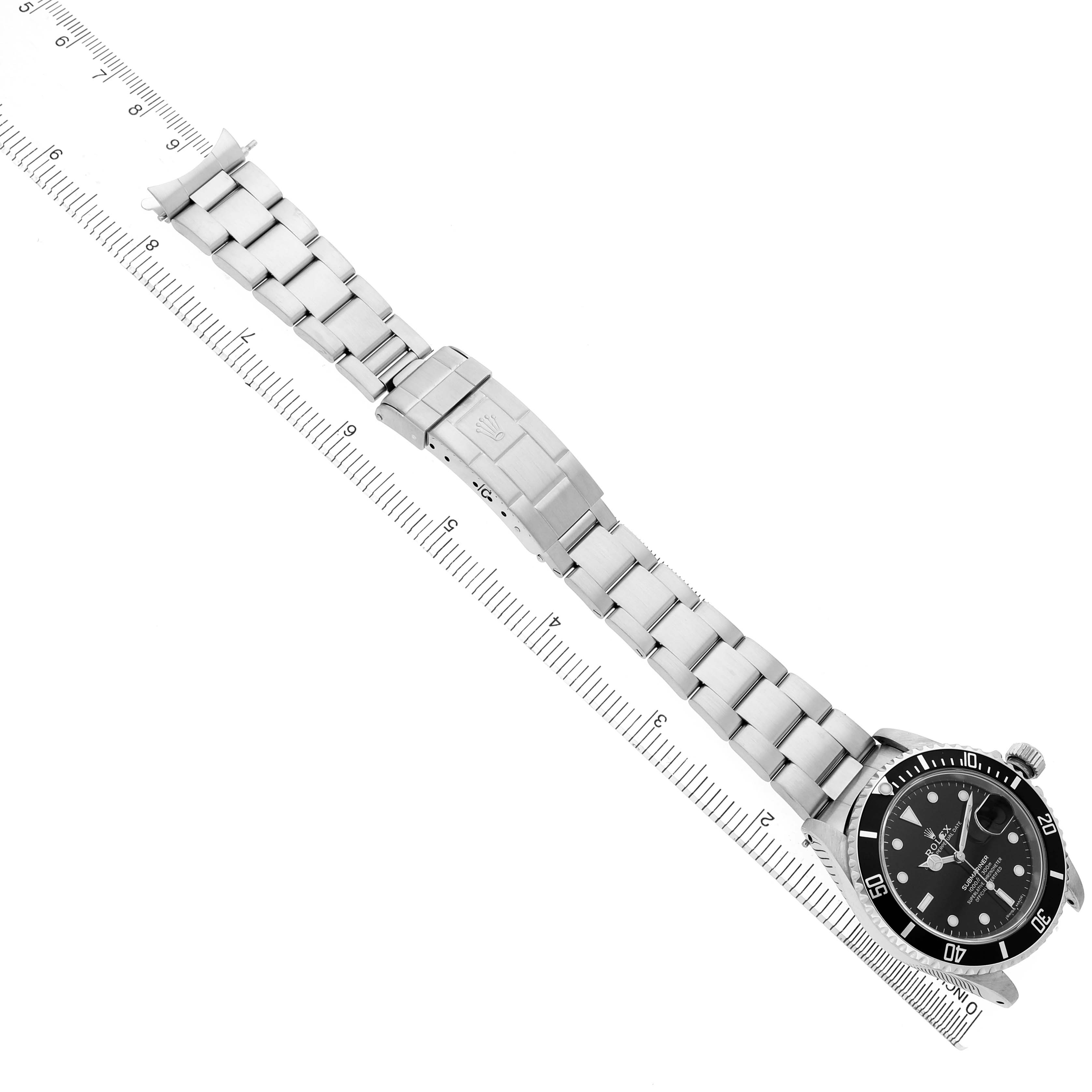 The Rolex Submariner 16610 Men's Stainless Steel Black Dial watch is shown from a top-down angle, highlighting the bracelet and clasp.