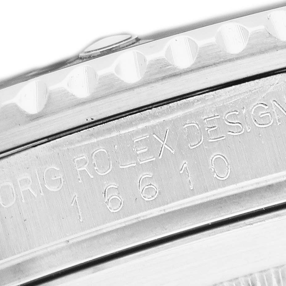 The image shows an angled close-up of the side of a Rolex Submariner 16610 Men's Stainless Steel Black Dial watch with engraved text.