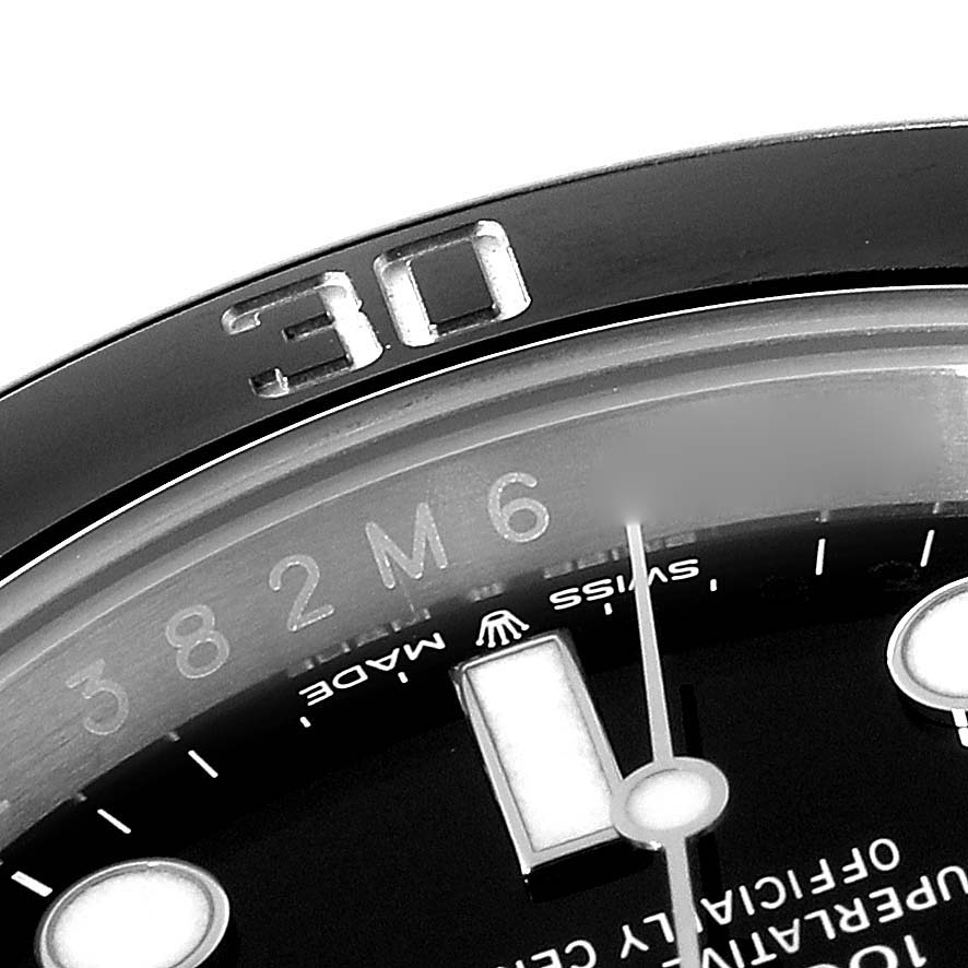 The image shows a close-up of a Rolex Submariner 124060 Men
s Stainless Steel Black Dial 124060 Men
s Stainless Steel Black Dial
s bezel and dial with the "30" marker and a partial view of the hour markers and text.