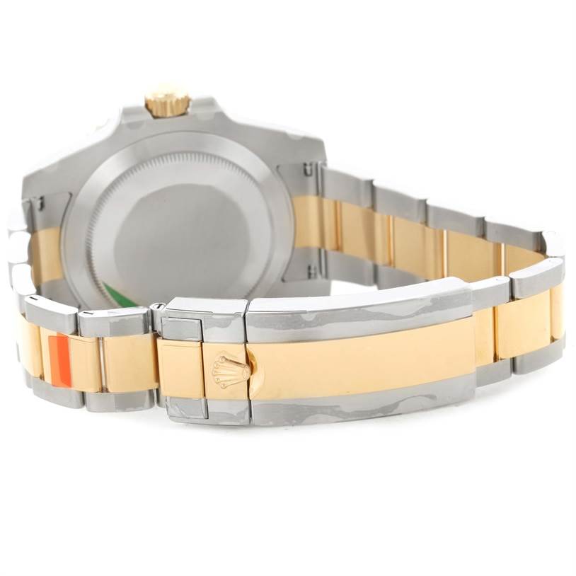 The image shows the back case and bracelet of a Rolex Submariner 116613LN Men
s Steel and Gold (two tone) Black Dial 116613LN Men
s Steel and Gold (two tone) Black Dial watch, highlighting the two-tone metal clasp and links.