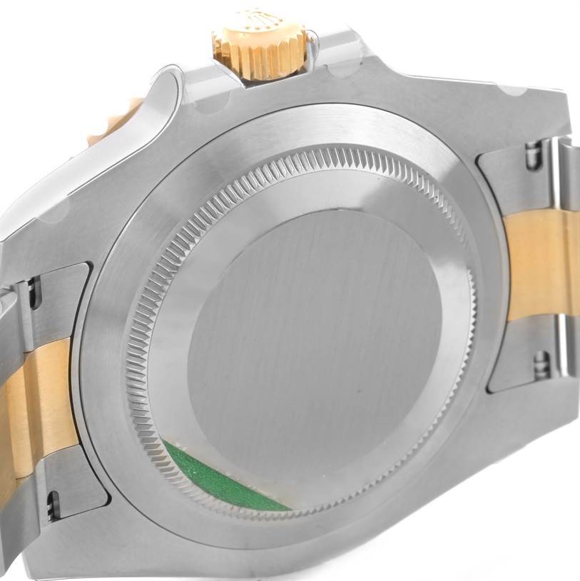 This image shows the back case and the crown of a Rolex Submariner 116613LN Men
s Steel and Gold (two tone) Black Dial 116613LN Men
s Steel and Gold (two tone) Black Dial watch from a side angle.