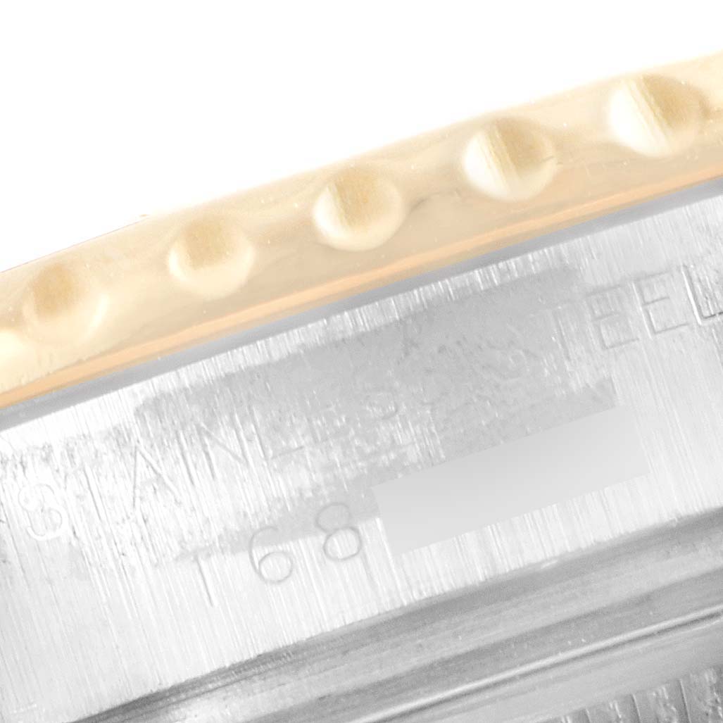 This image shows a close-up angle of the bezel and side case of a Rolex Yacht-Master 69623 Women's Steel and Gold (two tone) White Dial 69623 Women's Steel and Gold (two tone) White Dial watch, highlighting the textured bezel and part of the serial number stamp.